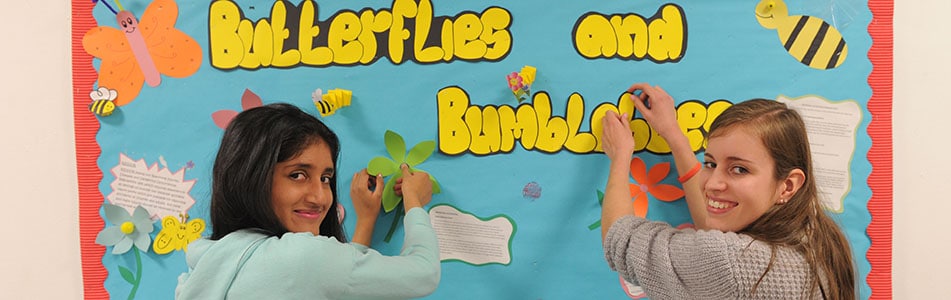 Early years students working on display wall